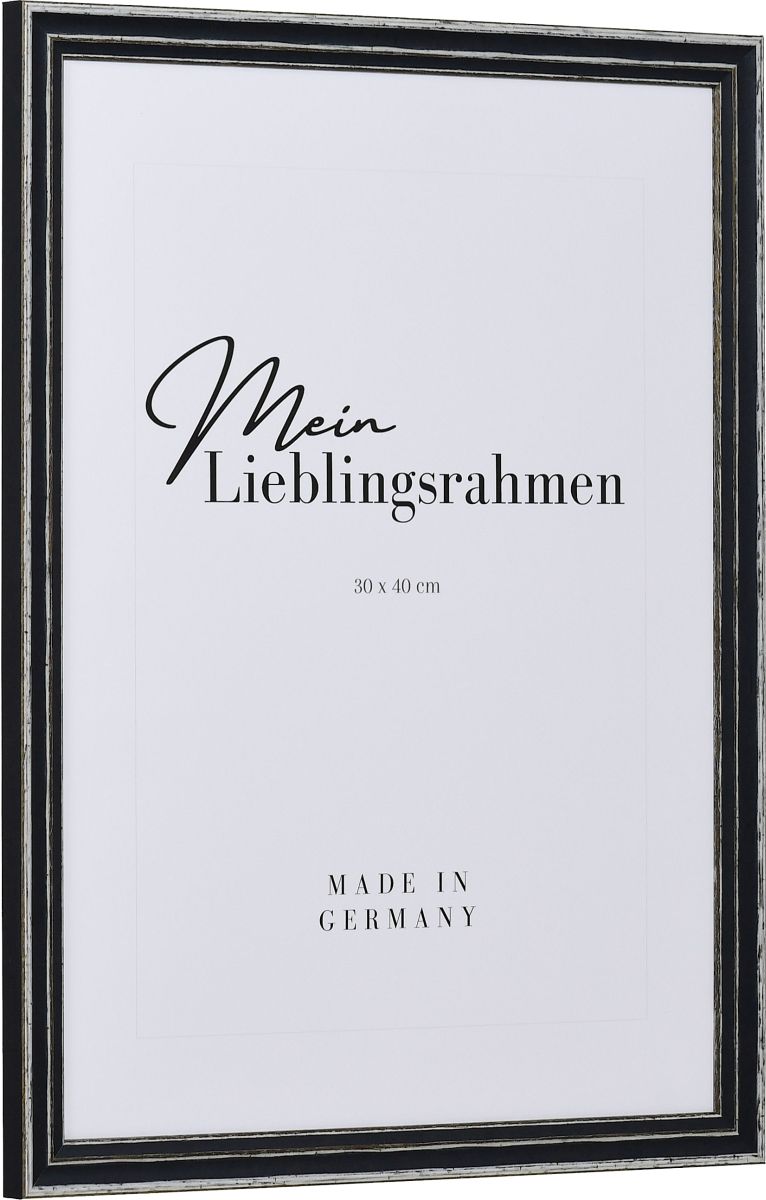 Seitenansicht eines grauen, offenporigen, Shabby Rahmens mit an den Kanten abgeriebener Farbe