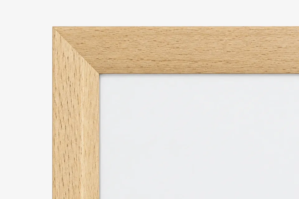 Hoek van een fotolijst van licht hout met zichtbare nerf